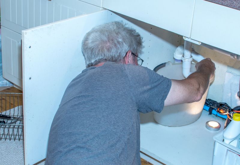 Plumber Fixing a Pipe